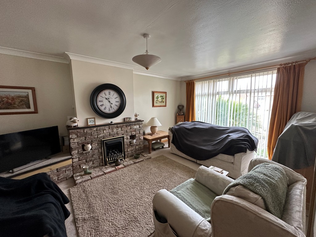 Lot: 1 - TWO-BEDROOM SEMI-DETACHED BUNGALOW WITH GARAGE AND GARDEN - Living Room overlooking front garden
